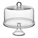 An Acopa clear glass cake stand with a round glass cover.