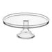 A clear glass Acopa cake stand with a pedestal.