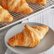 A plate of croissants on a cooling rack with Saf Pro Dough Improver.