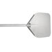 A silver pizza shovel with a handle hanging on a white stand.