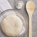 a white dough in a glass bowl