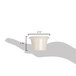 A hand holding a small ivory melamine ramekin with a handle.