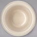 A Carlisle ivory bone ramekin on a gray surface.
