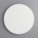 A white circular melamine-coated wood cake board.