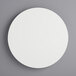A white circular wood cake board.
