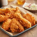 A tray of fried chicken breaded with Texas Fried Chicken Breading on a table.