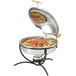 A Vollrath black wire chafer stand holding a chafing dish on a table.