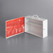 A white metal box with a red pocket organizer inside.