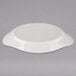A white oval Hall China rarebit dish with text on it.