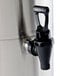 A Bunn stainless steel iced tea dispenser with a black faucet.