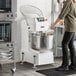 An industrial spiral dough mixer with a large stainless steel bowl and control panel, designed for commercial baking operations.
