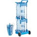 a blue cart with a stack of water bottles