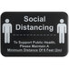 A black Tablecraft sign with white text reading "Social Distancing" and people icons.