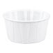 A small white paper souffle or portion cup.