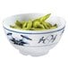 A close up of a blue and white Water Lily melamine bowl filled with green beans.