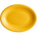 An Acopa Capri mango orange oval stoneware coupe platter with a rim and a circle in the middle.