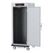 A white metal Metro holding / proofing cabinet with shelves and a solid door.