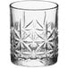 A close up of an Acopa Gardenia Rocks glass with a star pattern.