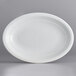 An Acopa Capri coconut white oval stoneware coupe platter.