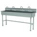 A stainless steel Advance Tabco multi-station hand sink with four faucets.