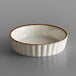 a white bowl with brown rim
