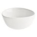 An Acopa Nova white stoneware bowl with a curved edge on a white background.