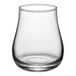 An Acopa Select whiskey glass with a small amount of liquid in it.