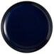 An Acopa Keystone Azora Blue stoneware coupe plate with a black rim and white spots on a dark blue background.