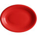 An oval red Acopa Capri stoneware platter with a white rim.