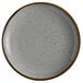An Acopa Keystone granite gray stoneware coupe plate with speckles.