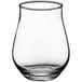 An Acopa Select stemless tulip glass with a small amount of liquid in it on a white background.