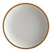 An Acopa Keystone Vanilla Bean stoneware coupe plate with brown specks.