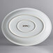 An Acopa Coconut White oval stoneware coupe platter with a circular design in black.