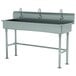 An Advance Tabco stainless steel multi-station hand sink with 3 electronic faucets.