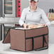A woman holding a Choice brown insulated bag with food in it.