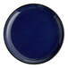A round, deep blue porcelain coupe plate.