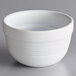 An Acopa Capri coconut white stoneware bouillon bowl with a handle.