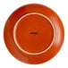 A round, orange stoneware coupe plate with the brand name 'Acopa' on the bottom.