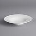 An Acopa Liana bright white porcelain pasta bowl with embossed lines and a wide rim.