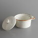 An Acopa Keystone white stoneware mini casserole dish with a lid.