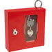 A red steel Barska emergency key box with a key inside.