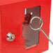 A red steel Barska emergency key box with a key inside.