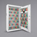 A white metal Barska wall-mount cabinet with many key tags.