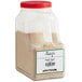 A plastic container of brown powdered Regal Maple Sugar with a red lid.