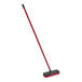 A red Libman floor scrub with a black and red handle.