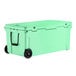 A seafoam green CaterGator outdoor cooler with black wheels.