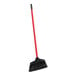 A Libman Housekeeper broom with a red handle.