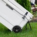 A white CaterGator outdoor cooler on grass.