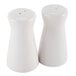 Two white ceramic tower salt and pepper shakers.