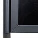 A black Aarco double pedestal poster stand.